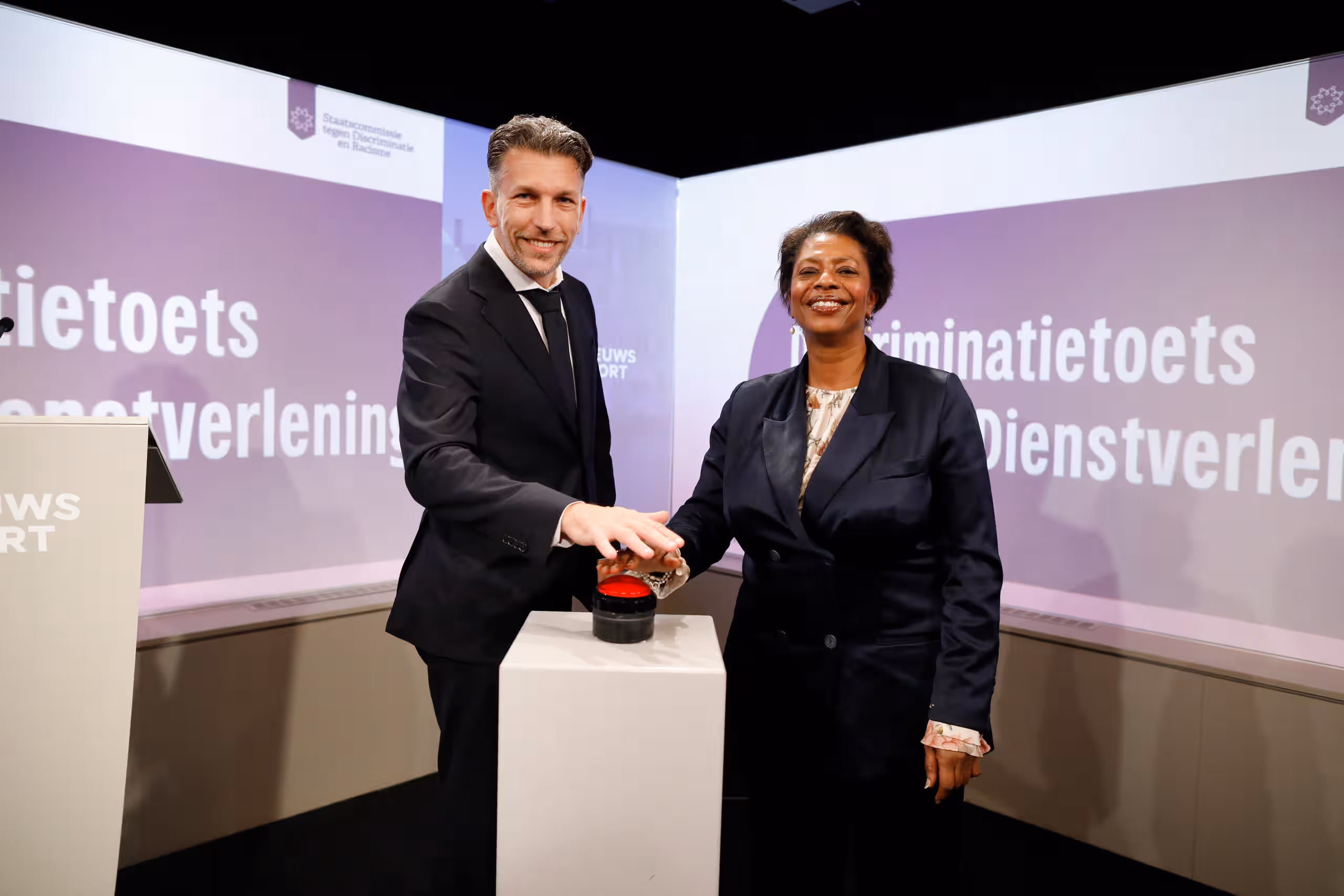 De voorzitter en de minister drukken op de knop om de Discriminatietoets te lanceren